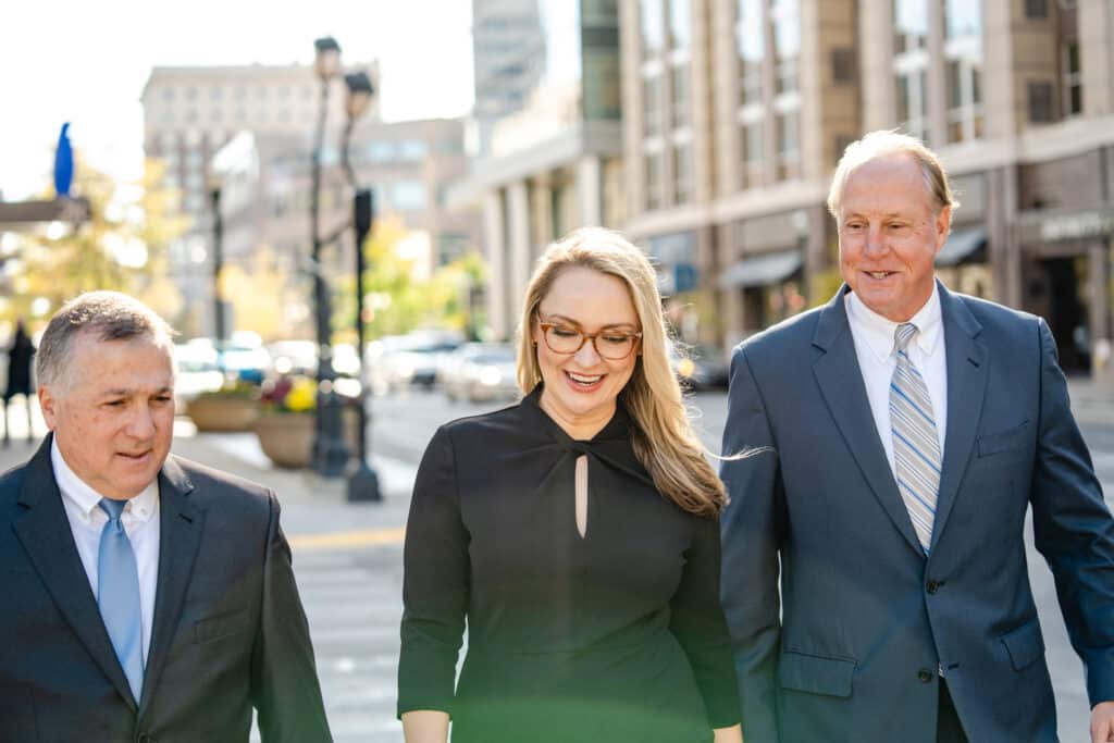 three WHT team members walking downtown